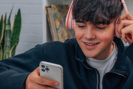 boy with mobile phone and headphones, teenagersの写真素材