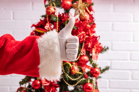 santa claus hand with okay and christmas treeの写真素材
