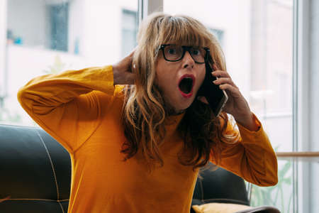 amazed woman with mobile phone