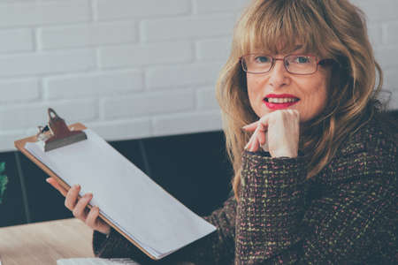 woman in office working with documentsの写真素材