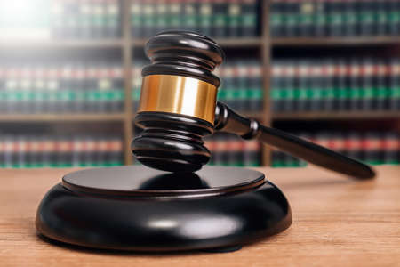 judge hammer with justice or law books in backgroundの写真素材