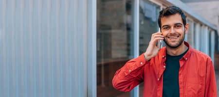 urban style man using mobile or cell phone in the street outdoorsの写真素材