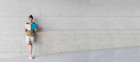 teen student with backpack and book at college or campusの写真素材