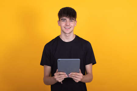male teenager with digital tablet isolated on backgroundの写真素材