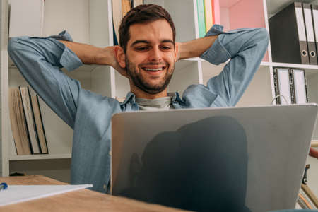man at home relaxed looking at the computerの写真素材