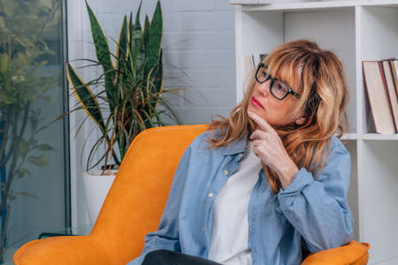 adult woman at home with thoughtful or worried expression
