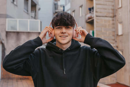 teen boy with headphones on the streetの写真素材