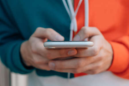hands of young man with mobile phone