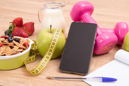 diet and nutrition background with mobile phone