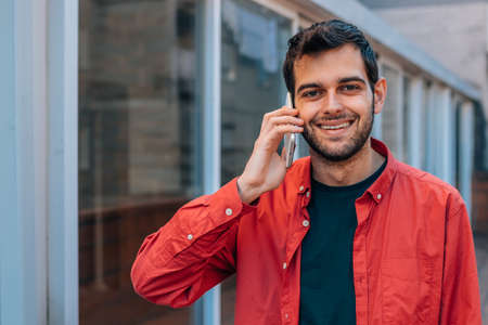 urban style man using mobile or cell phone in the street outdoors