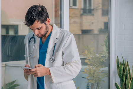 doctor with mobile phone in hands