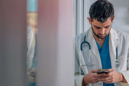 young doctor with mobile phoneの写真素材