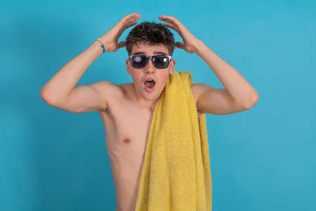 isolated teenager with sunglasses and towel, vacation and summer