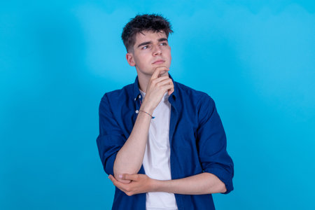 isolated young teenager with thoughtful expressionの写真素材
