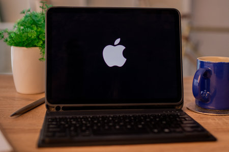Galicia, Spain - February 11, 2022: laptop on desk with apple backgroundのeditorial素材