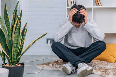 stressed or troubled young man at home