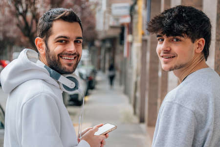 young people in the street looking at the camera smilingの写真素材