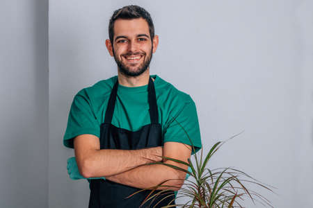 man with gardening work clothes and plants