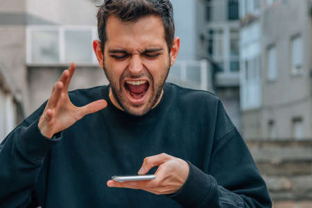 angry man yelling at mobile phone