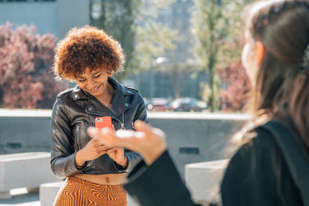 influencers filming on the street with a mobile phoneの写真素材