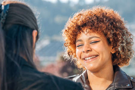 girls in the street talking smilingの写真素材