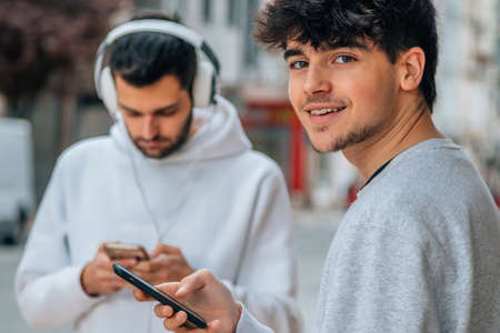 young people in the street with mobile phoneの写真素材