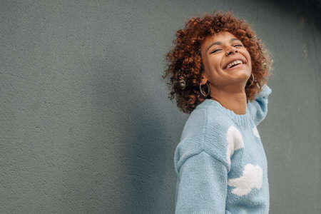 portrait young african american girl isolated on street wall