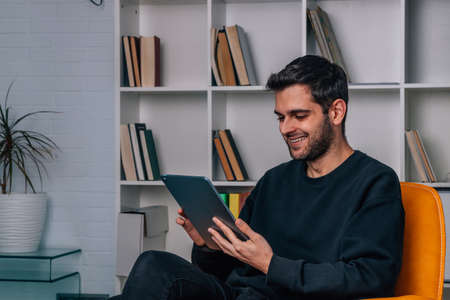 young man working at home with digital tablet or laptop