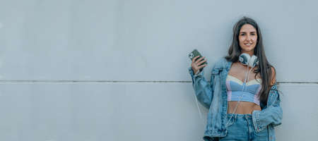 young girl with mobile phone on the street