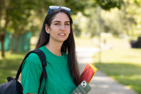 student girl with books outdoorsの写真素材