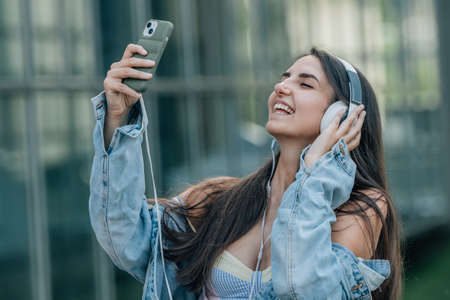 influencer with mobile phone and headphonesの写真素材