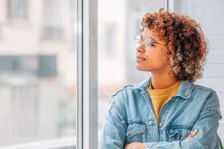 pensive girl or woman looking out the window