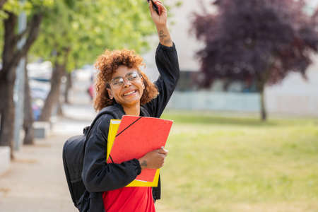 african american student girl smiling happy on campus outdoorsの写真素材