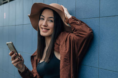 portrait of girl with mobile phone and hat