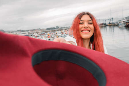 portrait of happy girl smiling with hat outdoors