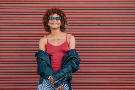 girl on the street isolated on red backgroundの写真素材