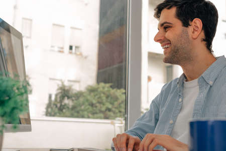 young man working typing on computerの写真素材