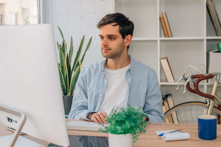 young man working at home with computerの写真素材