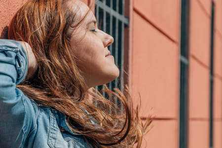 portrait of long-haired girl in profile on the wallの写真素材