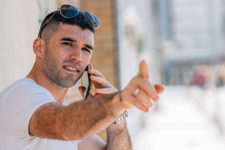middle aged man talking on mobile phone in the street