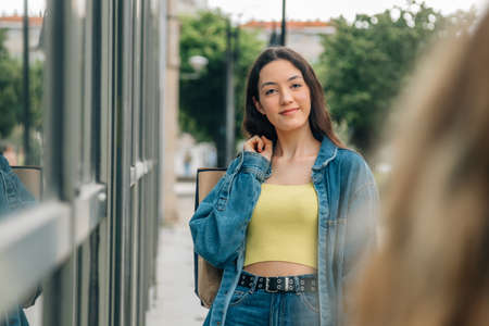 young girl with shopping bags on the street