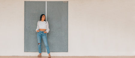 latin girl standing in the street full length with copy-spaceの写真素材
