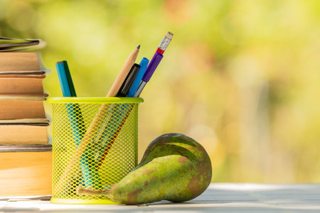 pot with pencils on desk outdoors, schoolの写真素材