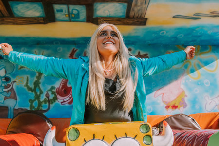 excited girl having fun at amusement park or fairの写真素材