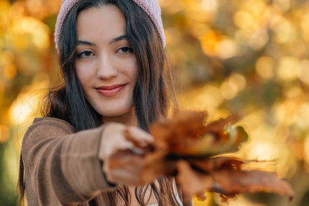girl in autumn with leaves outdoors