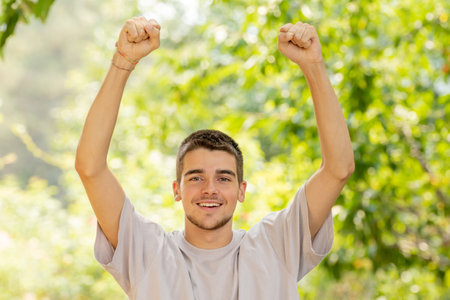 young man with successful expression outdoorsの写真素材