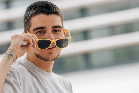portrait of young man in summer with sunglasses