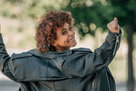 urban style latin black girl dancing happy in summer outdoorsの写真素材