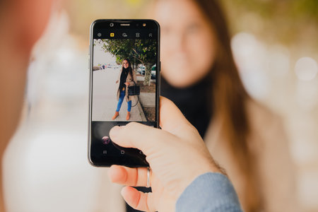 hand with mobile phone taking photo or videoの写真素材