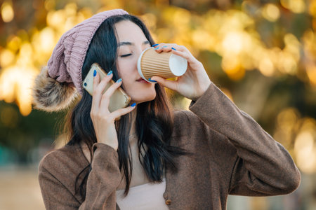 girl in autumn drinking outdoors